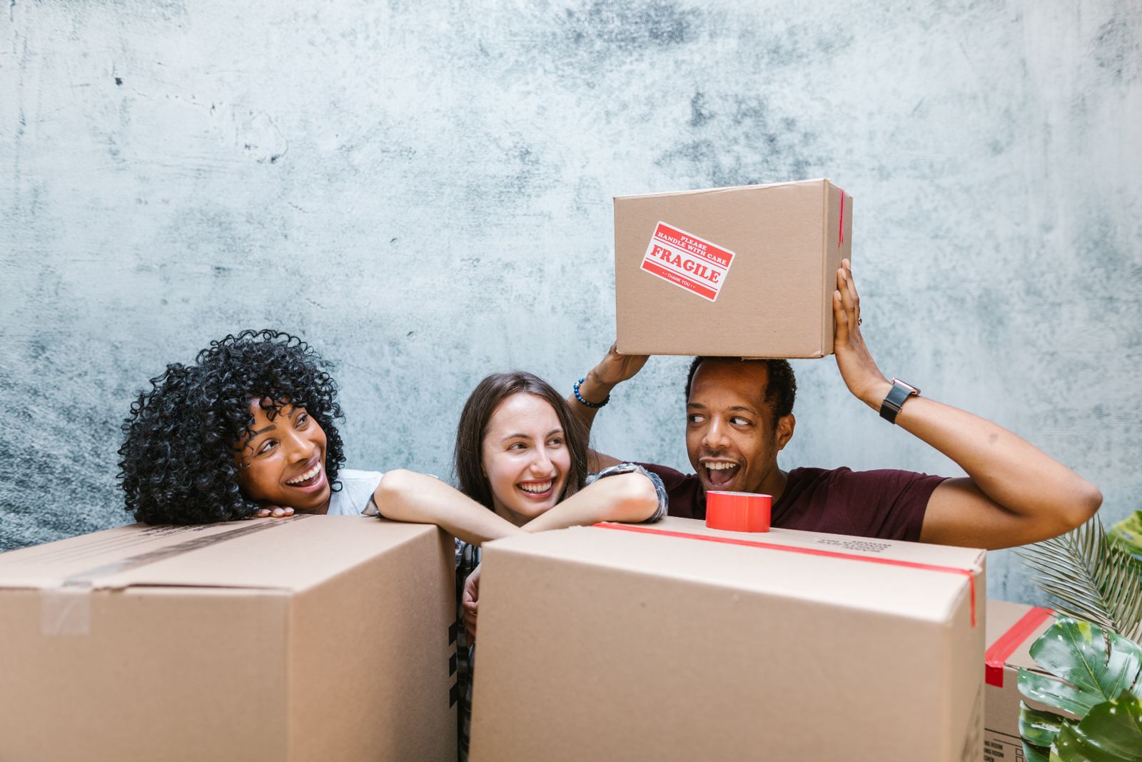 Crew members packing moving boxes together